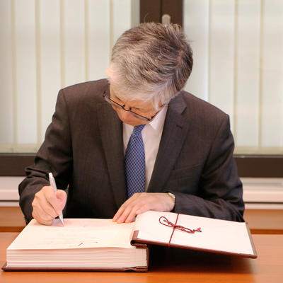 S.E. Takeshi Yagi trägt sich in das Goldene Buch ein.