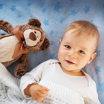 One year old baby with a teddy bear