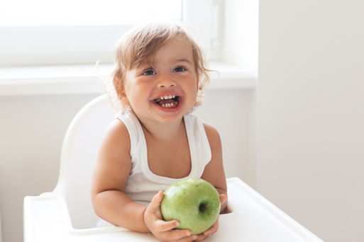 Baby eating fruit