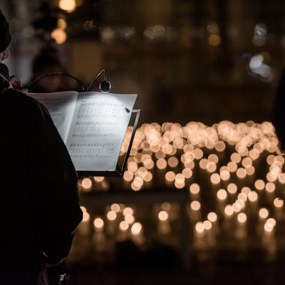 Musiker vor einem Notenblatt und tausenden brennenden Kerzen in Magdeburg