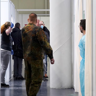 Ein Soldat und eine Helferin weisen die Impflinge im Impfzentrum Magdeburg ein