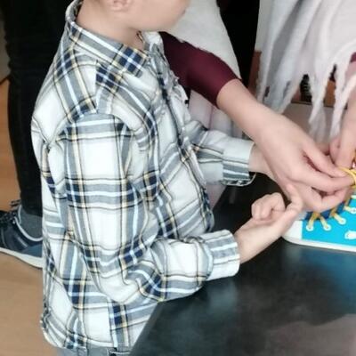 Kind bindet eine Schleife